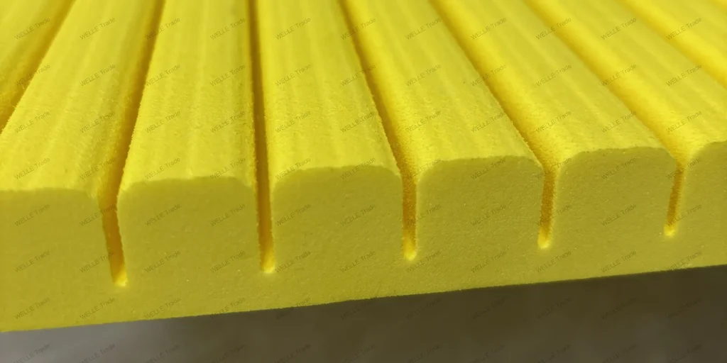 a close-up view of a series of yellow, cylindrical objects arranged in parallel rows. The objects have a smooth and uniform surface with a slight sheen, suggesting they might be made from a synthetic material such as plastic or rubber. Each cylinder is identical in size and shape, indicating that they are likely part of a larger set or product line. The texture on the surfaces appears to be consistent across all cylinders, which could imply a specific manufacturing process designed for durability or aesthetic purposes. The color yellow is bright and evenly distributed, without any visible imperfections or variations in hue. In terms of scale, while it’s difficult to determine exact dimensions due to the lack of reference points, the relative size of the cylinders suggests they are not extremely large, possibly measuring a few inches in length and diameter. Overall, this image conveys an industrial or mass-produced quality, highlighting the precision and consistency inherent in modern manufacturing techniques.