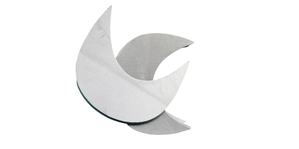 a modern abstract artwork in a minimalist style. The background is a pure white expanse, which serves as a clean and uncluttered backdrop for the main subject. The main element is a group of curved sheets with a silver - metallic finish. These sheets are arranged in an interlocking and overlapping manner, creating a visually appealing and geometrically - structured composition. There is no text in the image. The overall aesthetic is defined by simplicity, relying on the straightforward form and a single - color scheme to form the core of the visual presentation.