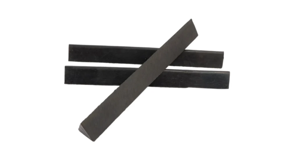 three black rectangular objects with a matte finish, arranged in an overlapping manner against a white background. The objects appear to be made of the same material and have similar dimensions, suggesting they could be parts or components used for a specific purpose.
