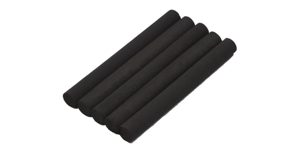 a group of black cylindrical objects placed on a white background. These objects are arranged in two rows, with four objects in the upper row and three in the lower row. The size of these objects appears to be consistent, suggesting they may be the same type of item. Due to the lack of specific details or distinguishing features, it is difficult to determine what exactly these objects are without additional context.