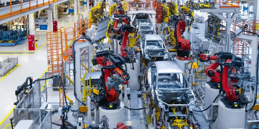 In the factory, robots and humans work together to complete the car manufacturing process. They move flexibly and operate various mechanical arms with precision, assembling metal parts into complete vehicles. With the assistance of machines, workers can carry out production tasks more efficiently, greatly improving productivity.