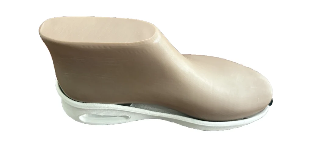a shoe last has a smooth, beige upper part and a white sole. It is used in the shoe - making process to shape footwear, ensuring proper fit and form during manufacturing. The simple and clean design highlights its functional role in the production of shoes.
