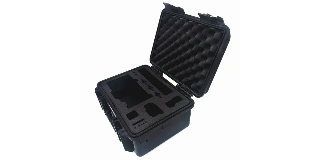 AlternativeText: An open black protective case with custom - cut foam inserts for secure equipment storage. Caption: Open Black Protective Case with Custom Foam Inserts for Equipment Description: This image displays a black protective case, opened to showcase its interior. The case features custom - cut black foam inserts with precisely shaped compartments, designed to securely hold and organize equipment, ensuring protection during transit. The top lid contains a honeycomb - patterned foam layer for added cushioning. Each compartment is tailored to fit items snugly, minimizing movement and potential damage.