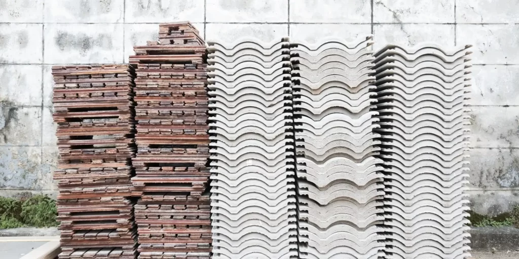 The picture shows a large pile of bricks and a large pile of concrete slabs.