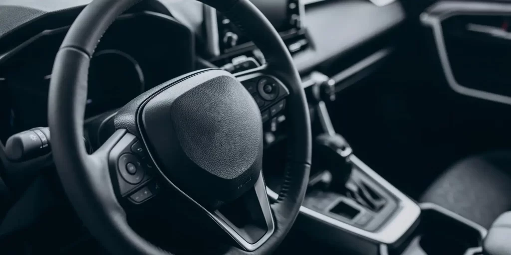 The steering wheel of the car, located in the center of the car. Black metal with exquisite details. Hold it in your hand and feel its warmth and comfort.