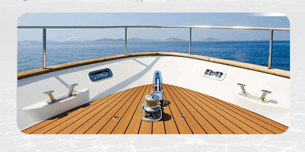 the bow of a luxurious yacht, with its sleek design and pristine condition. The deck is made from polished wood that gleams under the sunlight, complemented by white walls that curve gracefully around it.