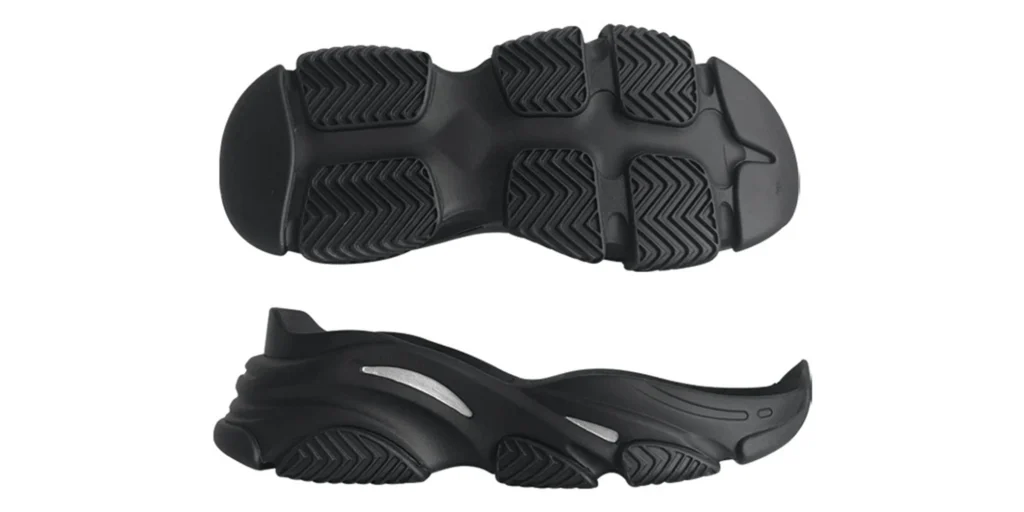 a black sneaker sole with two distinct perspectives. The top view showcases a unique tread pattern featuring multiple segmented, zig - zag - textured pads, likely engineered for enhanced traction. The side view reveals a layered, sculptural structure with sleek silver accents, suggesting both aesthetic appeal and potential functional benefits like shock absorption. The sole appears to be made of durable material, designed to support movement while adding a modern, stylish element to footwear.