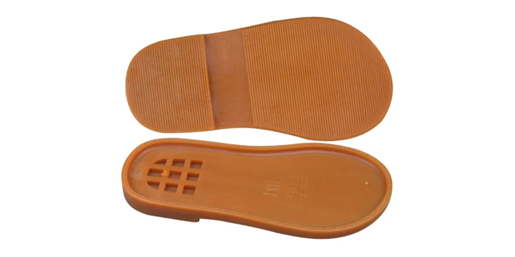 two brown shoe soles. The upper sole features a simple, striped tread pattern, likely designed for basic traction. The lower sole reveals an inner structure with a grid - like cutout section, which may contribute to flexibility and weight reduction. These soles appear to be made of a durable rubber material, suitable for crafting footwear with a focus on functionality and perhaps casual use.