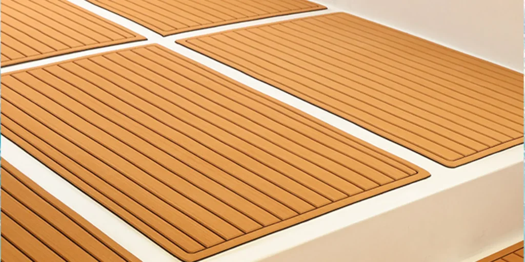 a close-up view of several rectangular pieces of flooring with a wood-like texture and pattern. The color is a warm brown, reminiscent of natural wood tones. Each piece has a series of parallel grooves running across its surface, giving it the appearance of wooden planks. They are laid out in an overlapping fashion on what seems to be a white background or base, suggesting that they might be part of a larger floor installation.
