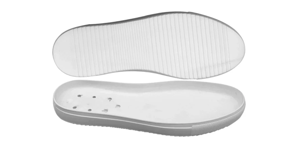 a white shoe sole in two views. The upper view showcases a tread pattern with parallel ridges, likely designed for traction. The lower view reveals the inner surface, which has several small holes, possibly for breathability or weight reduction. The sole appears to be made of a smooth, durable material, suitable for various footwear types to provide support and functionality.