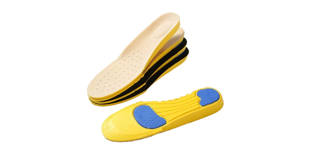 a collection of insoles. There’s a stack of insoles with alternating yellow, black, and beige layers, likely offering varied support or cushioning options. Additionally, a single yellow insole with blue, textured cushioning zones (probably for heel and arch support) is displayed. These insoles are designed to enhance foot comfort, provide arch support, and may help with alignment or pain relief, suitable for customizing footwear to meet different foot care needs.