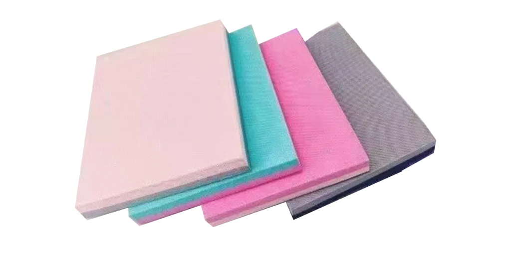 four pieces of foam board stacked together against a white background. From left to right, they are pink, teal, purple, and gray respectively. These boards have a smooth surface texture and appear to be made of soft material. They might be used for various purposes like insulation, packaging, or crafting projects.