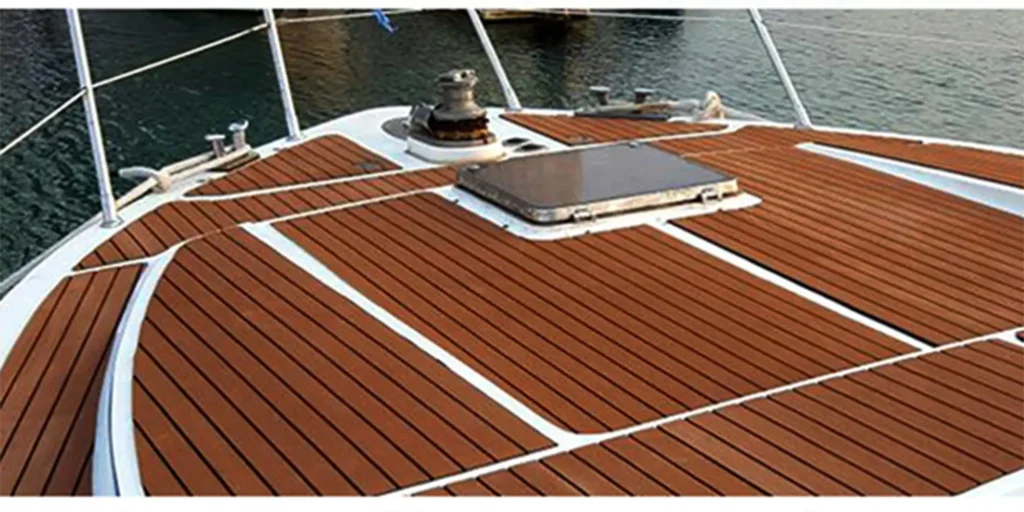 two different perspectives of a boat’s deck. On the left, we see a close-up view of the bow area with its wooden decking and various fixtures such as cleats for mooring lines and what appears to be a hatch or access point. The right side provides a broader perspective, showing more of the deck layout including seating areas with backrests, storage compartments, and additional fixtures that suggest functionality for navigation and safety equipment. Both views highlight the sleek design and attention to detail in the boat’s construction.